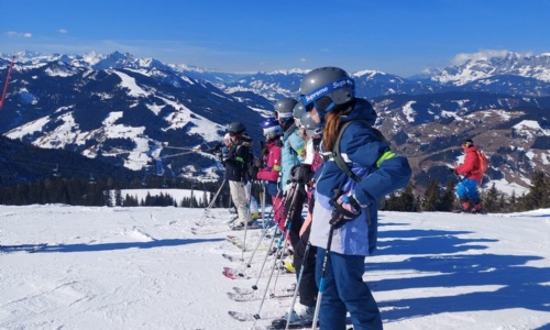 A group of students learning to ski in the  mountains